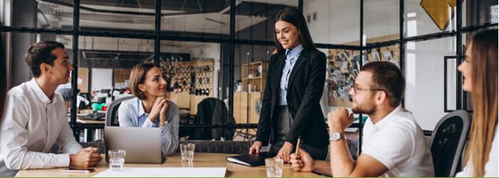 people working at a conference table with waters