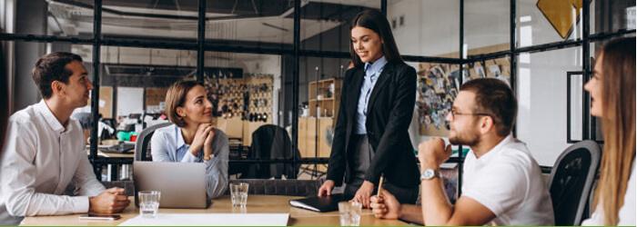 people working at a conference table with waters