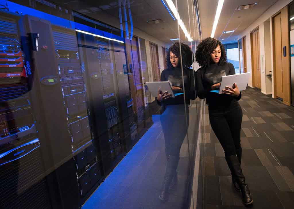 woman holding a laptop in a server room 2