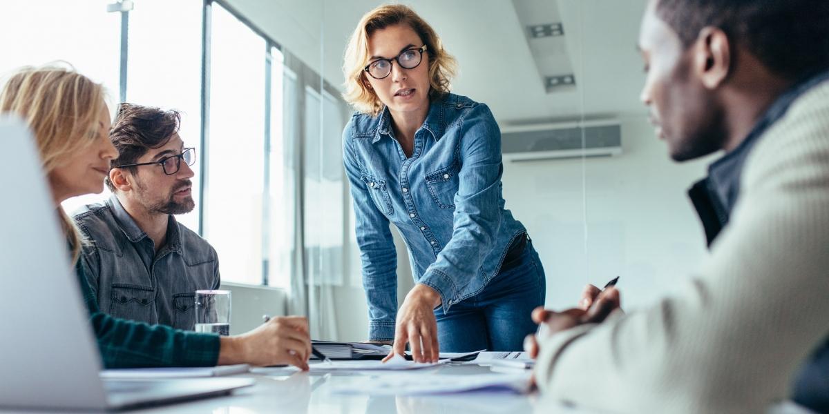 IT leadership team discussing governance responsibilities and oversight during a strategy meeting